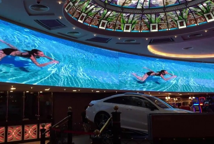 Indoor high resolution LED screen of girl in a swimming pool inside a casino lobby